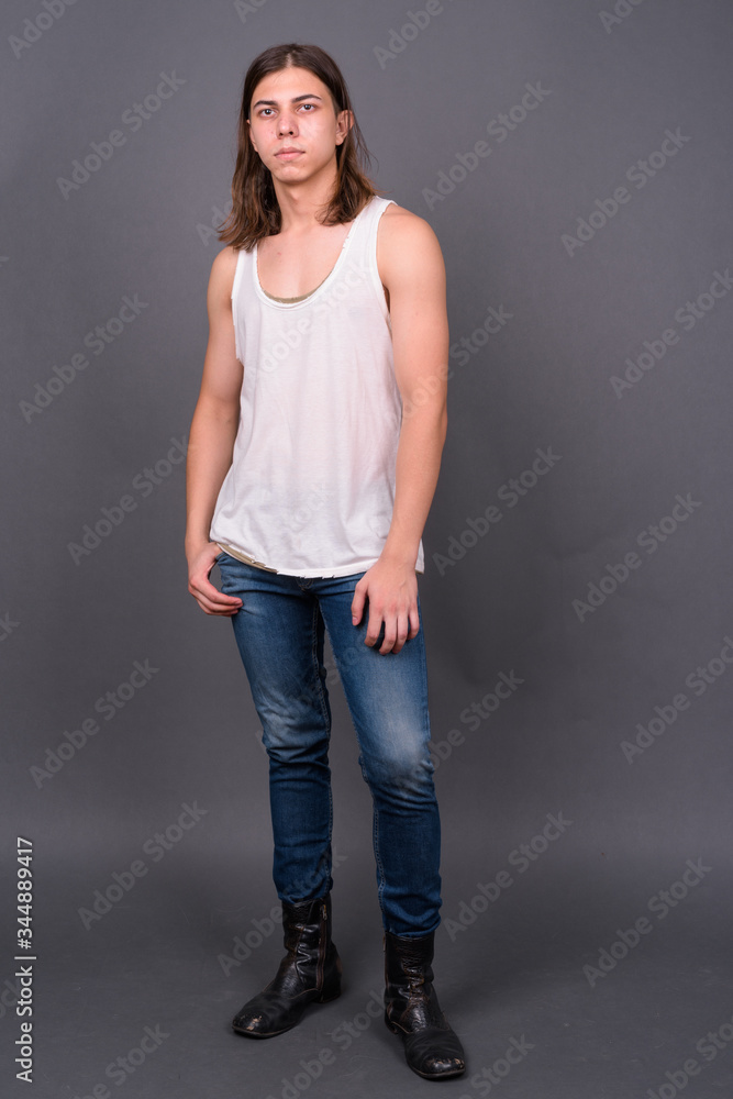 Young handsome androgynous man with long hair Young handsome androgynous man with long hair
