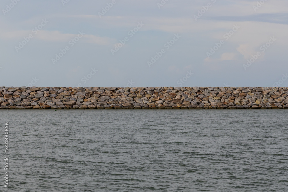 Large stones Was prepared in place of the sandy beach for the wave walls