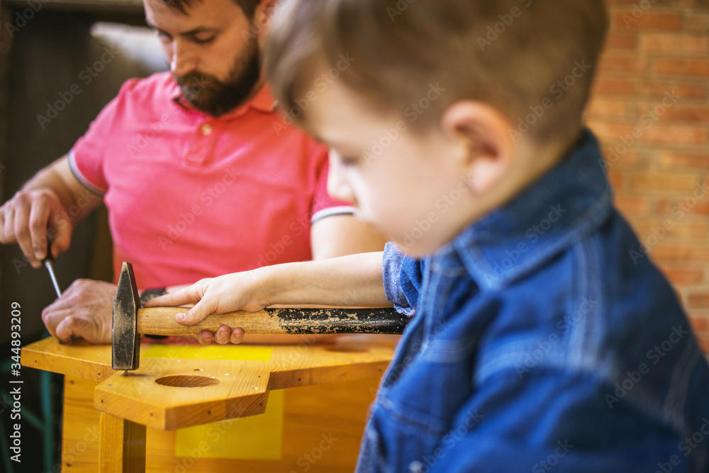 Father and Son Making a Birdhouse Father and Son Making a Birdhouse