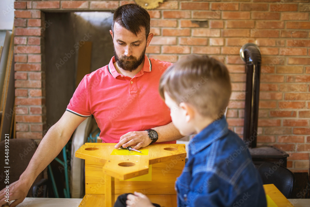 Father and Son Making a Birdhouse Father and Son Making a Birdhouse