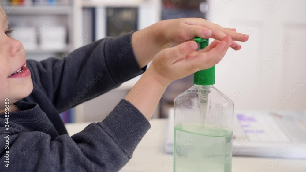 Toddler Applying Sanitizer On His Hands. Stable close up video showing blond boy using sanitizer at home. Toddler Applying Sanitizer On His Hands. Stable close up video showing blond boy using sanitizer at home.