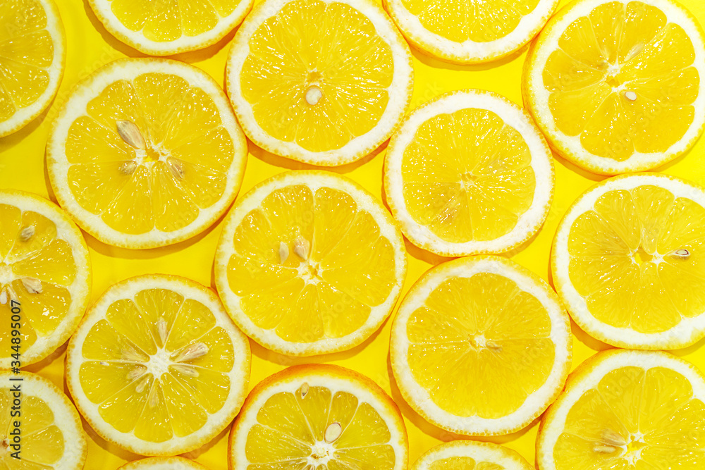 Lemon cut in half background. A slices of fresh yellow lemon pattern. Lemon pieces in different sizes.