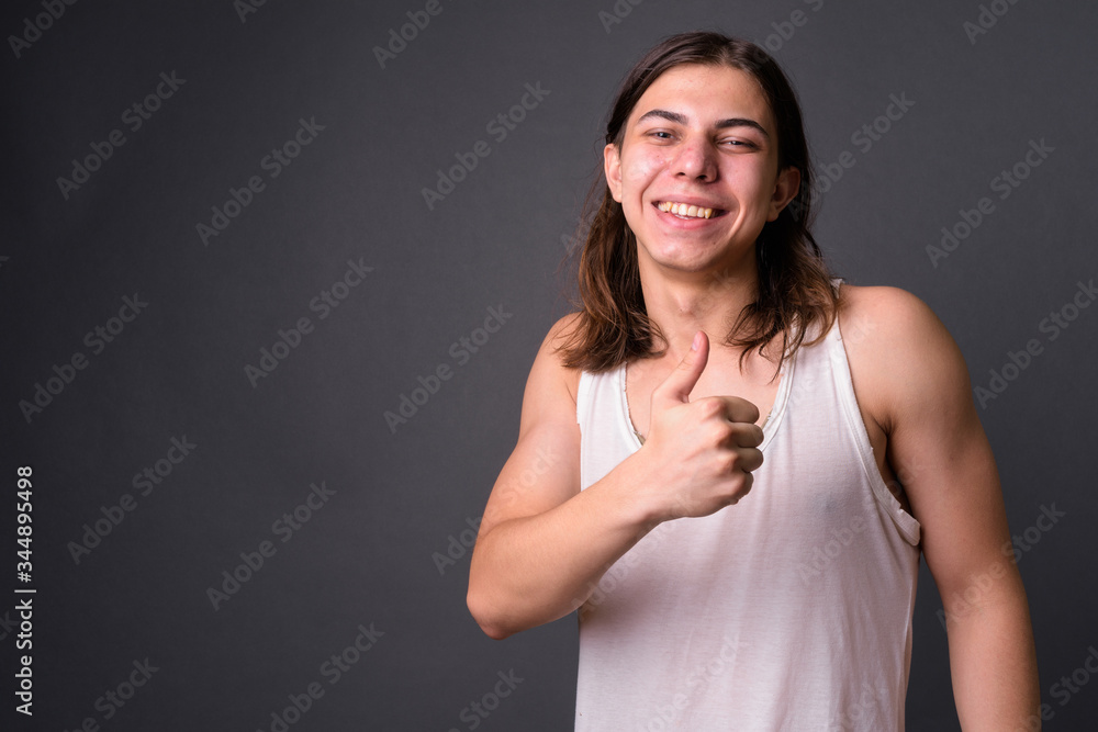 Young handsome androgynous man with long hair Young handsome androgynous man with long hair