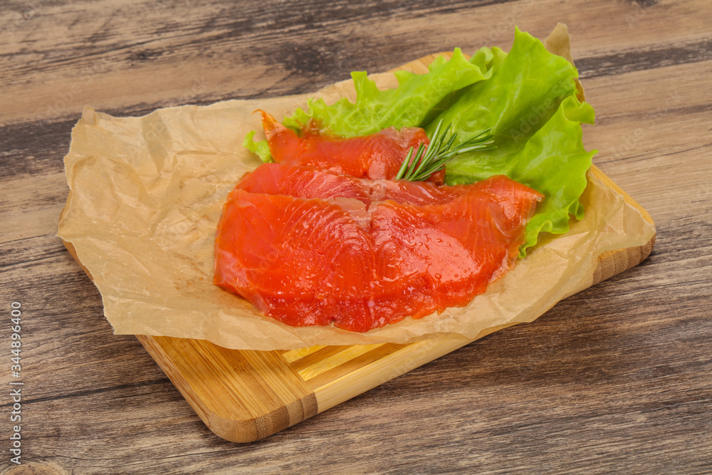Sliced salmon fillet served rosemary