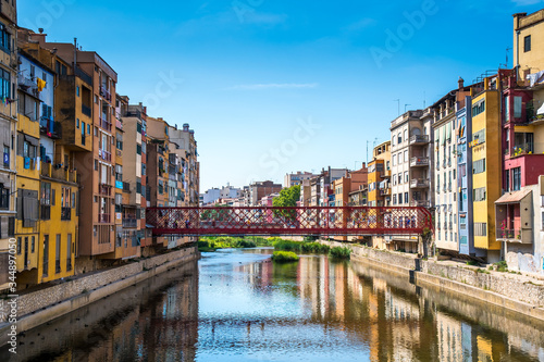 Colorful houses and Eiffel bridge over Onya river in Girona, Spain