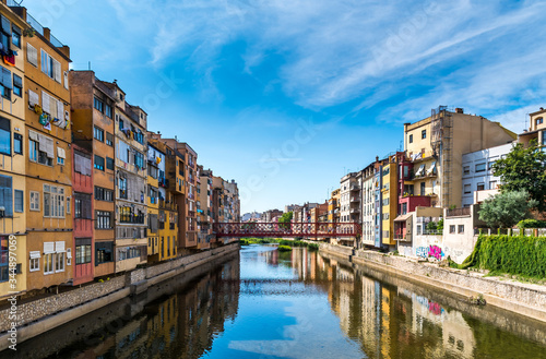 Colorful houses and Eiffel bridge over Onya river in Girona, Spain