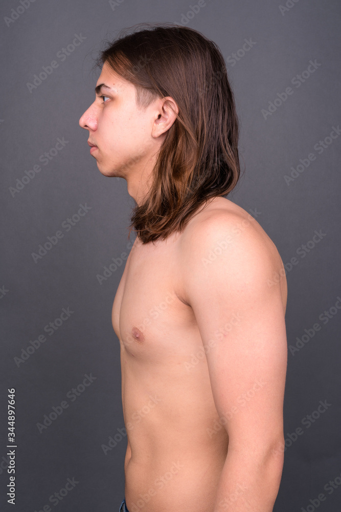 Young handsome androgynous man with long hair shirtless Young handsome androgynous man with long hair shirtless