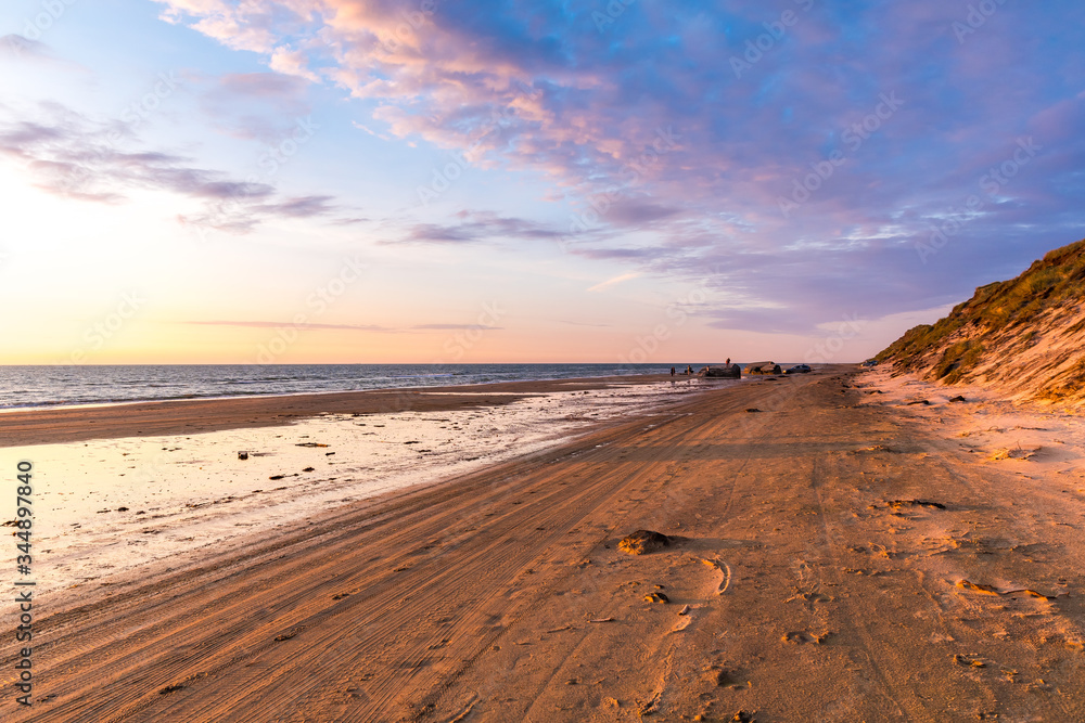 Beautiful wide beach in golden sunset light and dramatic sky Beautiful wide beach in golden sunset light and dramatic sky