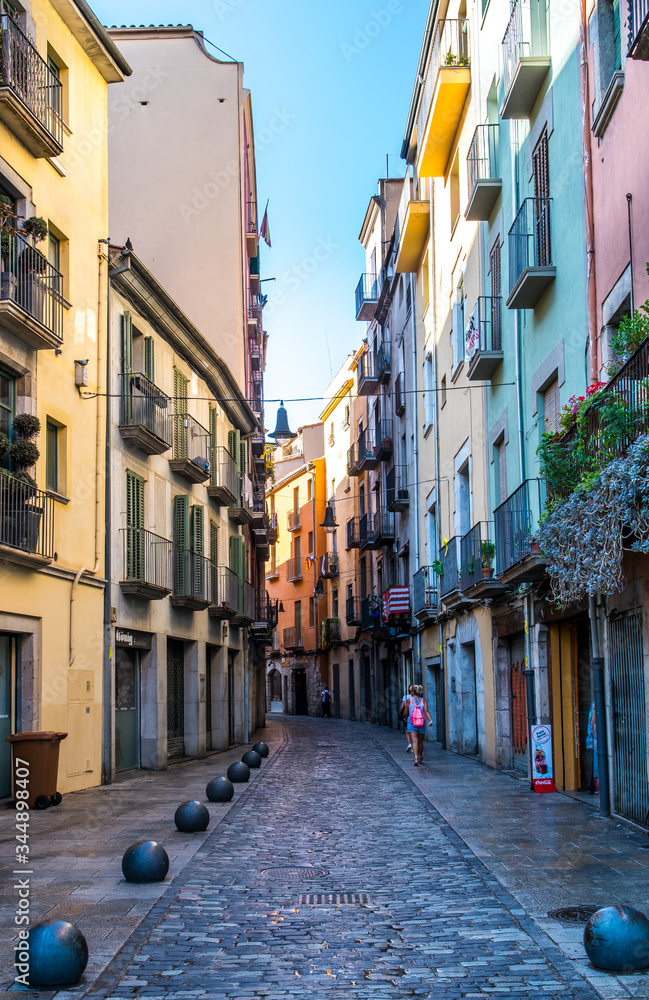 Small cobbled street with colourful houses in Girona, Spain