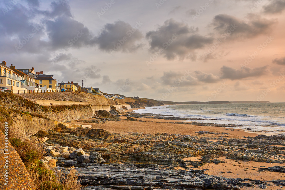 Image of the beach at Porthleven, Cornwall with rocks, cottages, waves and cloudy sky Image of the beach at Porthleven, Cornwall with rocks, cottages, waves and cloudy sky