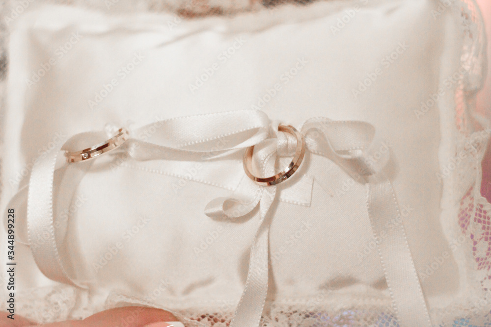 Wedding rings on the white pillow with flovers Wedding rings on the white pillow with flovers