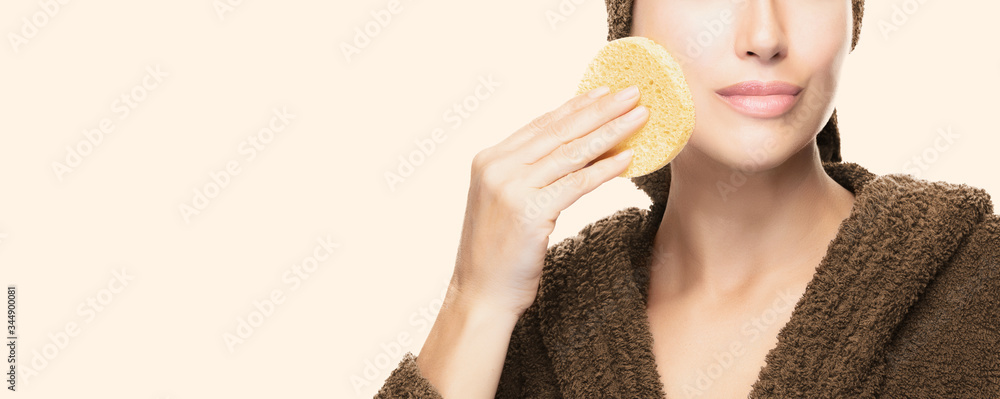 Healthy skin woman cleans her facial skin with a cosmetic sponge. Daily beauty and skin care routine Healthy skin woman cleans her facial skin with a cosmetic sponge. Daily beauty and skin care routine