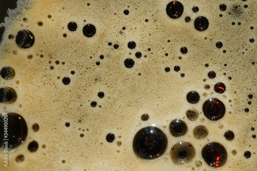 Konstfotografi Foam dark beer in glass, top view. Close up fresh froth porter