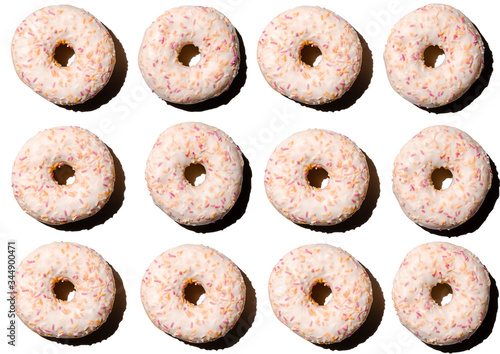 doughnuts in pink glaze on a white isolated background, pattern top view