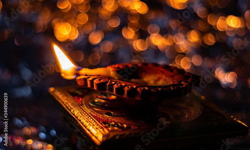 top view close up of beautiful diya on chuwki with bokeh background. diwali concept photo