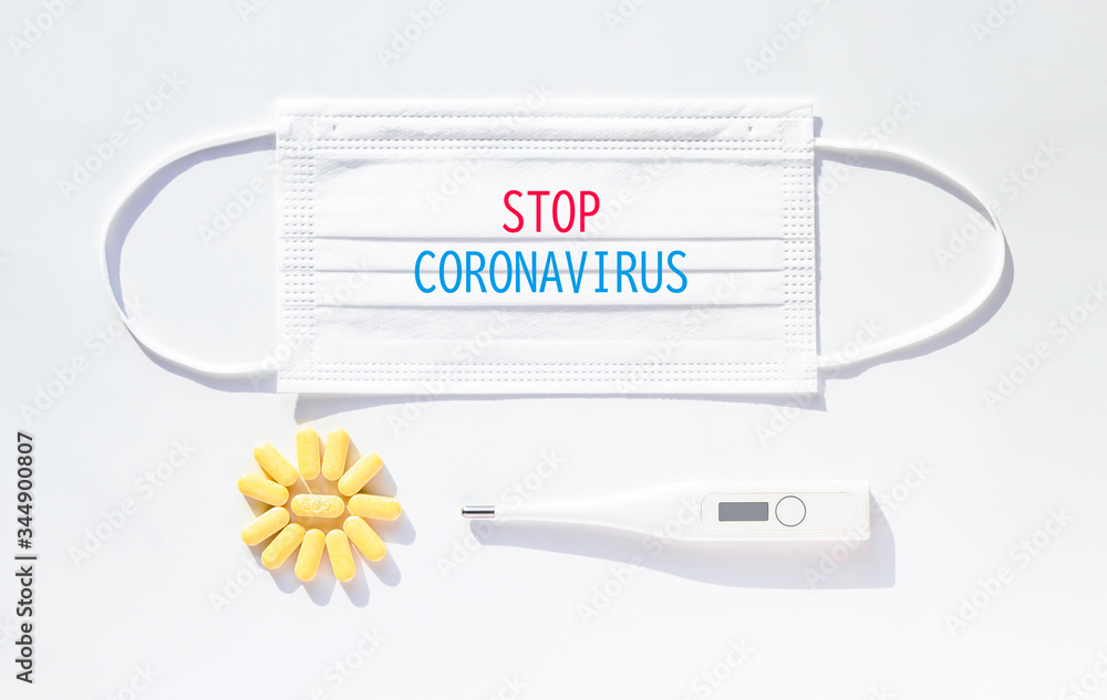 Stop Coronavirus respiratory outbreak with mask,Digital thermometer for measuring fever,Vitamin C tablets,on white background. Stop Coronavirus respiratory outbreak with mask,Digital thermometer for measuring fever,Vitamin C tablets,on white background.