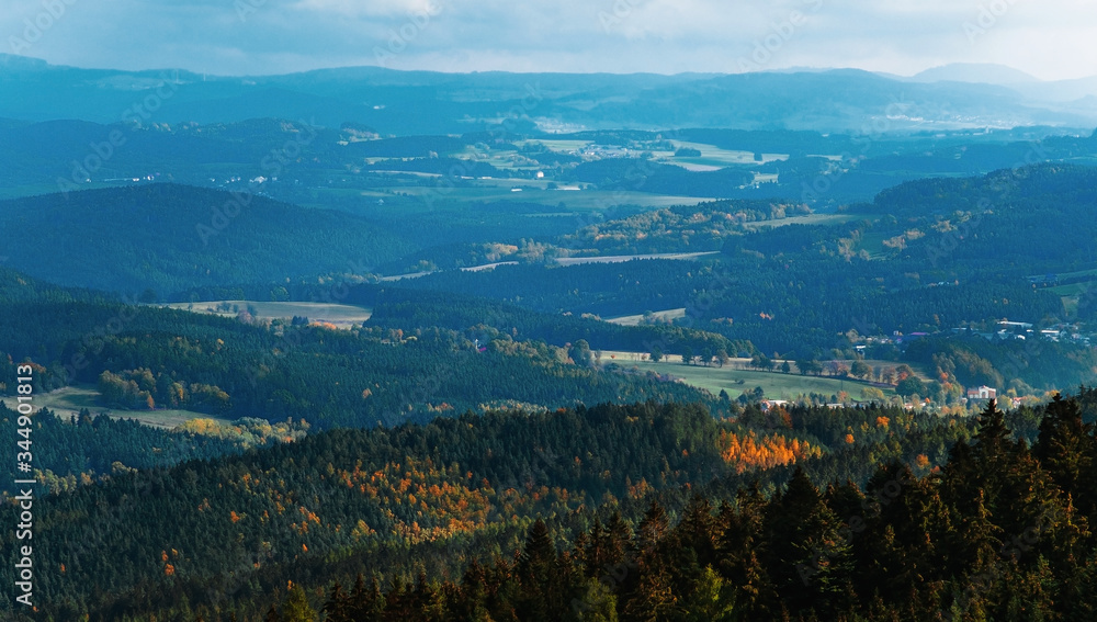 Beautiful landscape of hilly terrain going into the distance. Czech Republic location on the border with Austria. Autumn season hills in perspective. Forests and fields with trees.