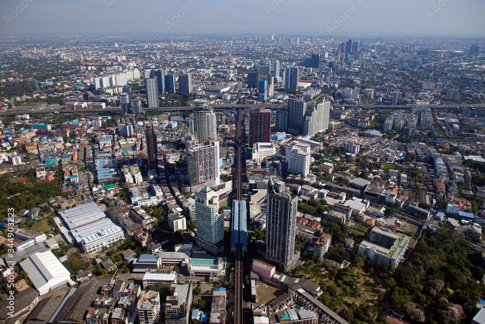 BANGKOK, THAILAND - JAN 1, 2019: Aerial photograph of Bangkok above the Skytrain station Go straight until there is a cross-section highway There are many buildings and houses. With a weird horizon.