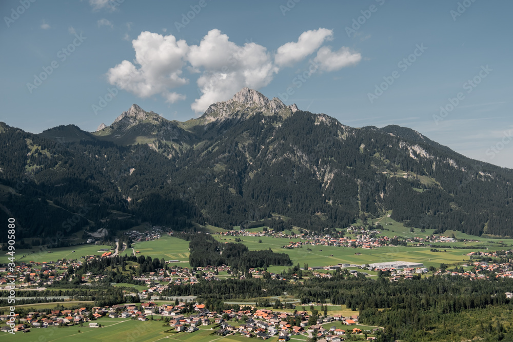 Germany. View of the alps and alpine village. Mountains, houses, sunny weather.