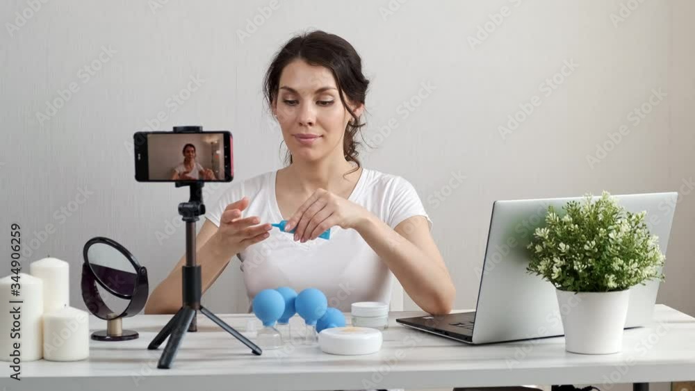 Influencer Girl blogger in medical mask talks about coronavirus. Woman recording video blog tells how to protect yourself from covid 19. Bloger talks mers-cov how to use of alcohol wipes,thermometer Influencer Girl blogger in medical mask talks about coronavirus. Woman recording video blog tells how to protect yourself from covid 19. Bloger talks mers-cov how to use of alcohol wipes,thermometer