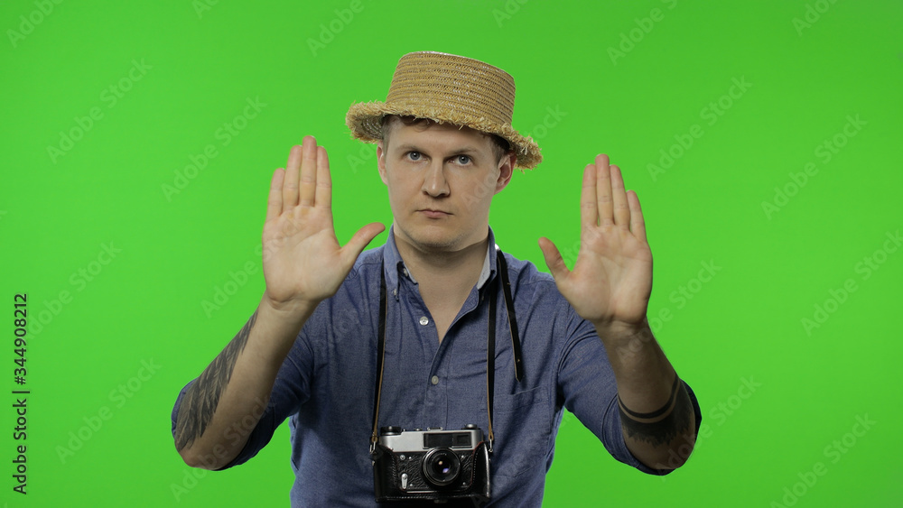 Portrait of young man tourist photographer show stop sign. Chroma key Portrait of young man tourist photographer show stop sign. Chroma key
