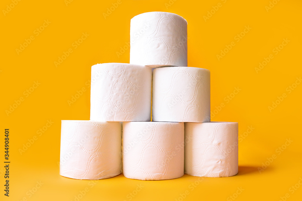 Toilet roll on a colored background, side view Space for text. Toilet paper in the shape of a pyramid Toilet roll on a colored background, side view Space for text. Toilet paper in the shape of a pyramid