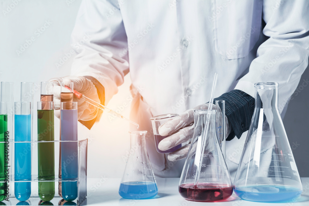 Fototapeta premium Researcher with glass laboratory chemical test tubes with liquid for analytical , medical, pharmaceutical and scientific research concept.