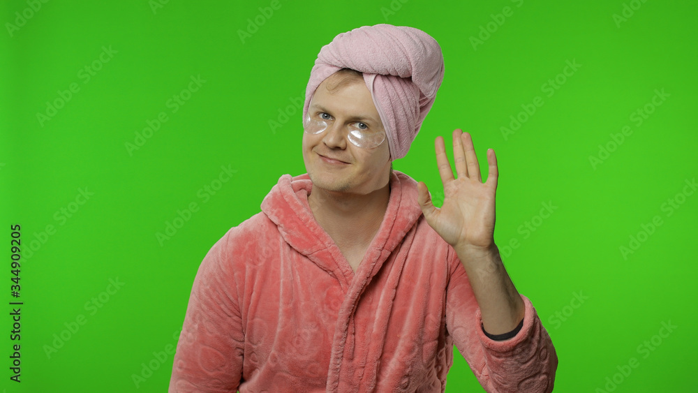 Portrait of transsexual man in bathrobe waves his hand. Chroma key Portrait of transsexual man in bathrobe waves his hand. Chroma key