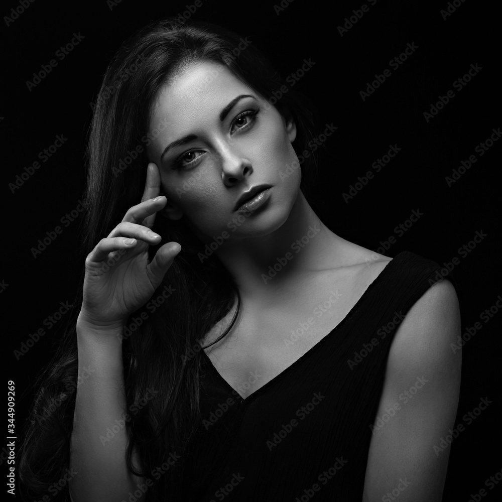 Beautiful makeup sexy woman with long hair looking serious with elegant hand and fungers near the face on black background. Closeup portrait. Art.Expression portrait. Beautiful makeup sexy woman with long hair looking serious with elegant hand and fungers near the face on black background. Closeup portrait. Art.Expression portrait.