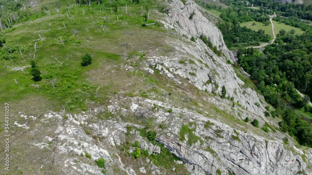 Copter the rocks. nature conservation area. A copter flies over the rocks. nature green trees and rocks. Copter the rocks. nature conservation area. A copter flies over the rocks. nature green trees and rocks.