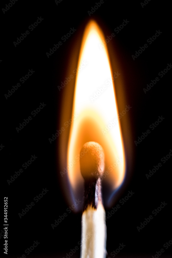 Burning match, on a black background. Macro shot,. Burning match, on a black background. Macro shot,.
