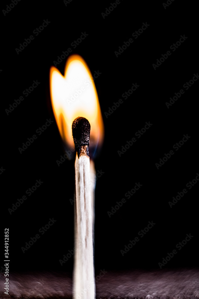Burning match, on a black background. macro shot. Burning match, on a black background. macro shot.