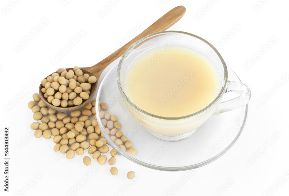 Soymilk in glass with soy beans in wooden spoon isolated on white backgroun, health care concept Soymilk in glass with soy beans in wooden spoon isolated on white backgroun, health care concept