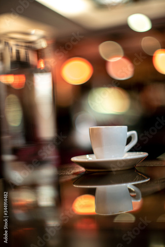 Cup of coffee espresso with glass of water bokeh sunlight sunshine daylight cafe house