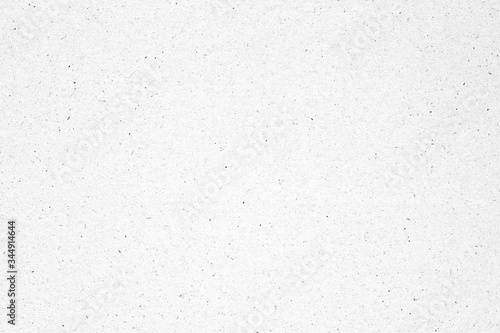 White paper or cardboard texture background with black spot.