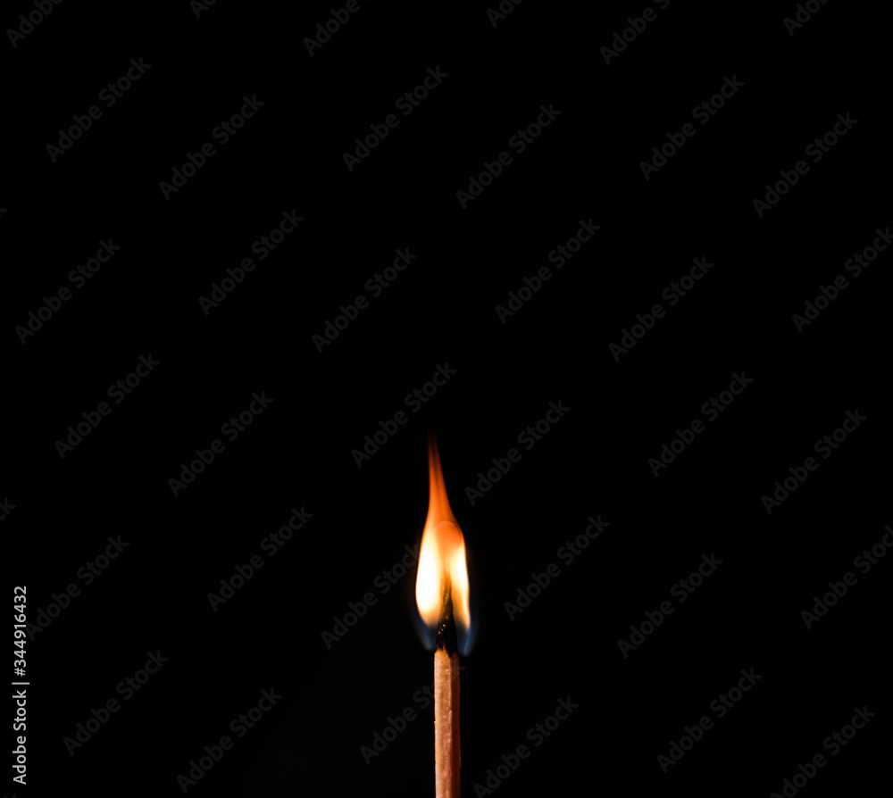 burning match on black background burning match on black background