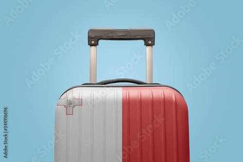 Baggage with Malta flag print tourism and vacation concept.