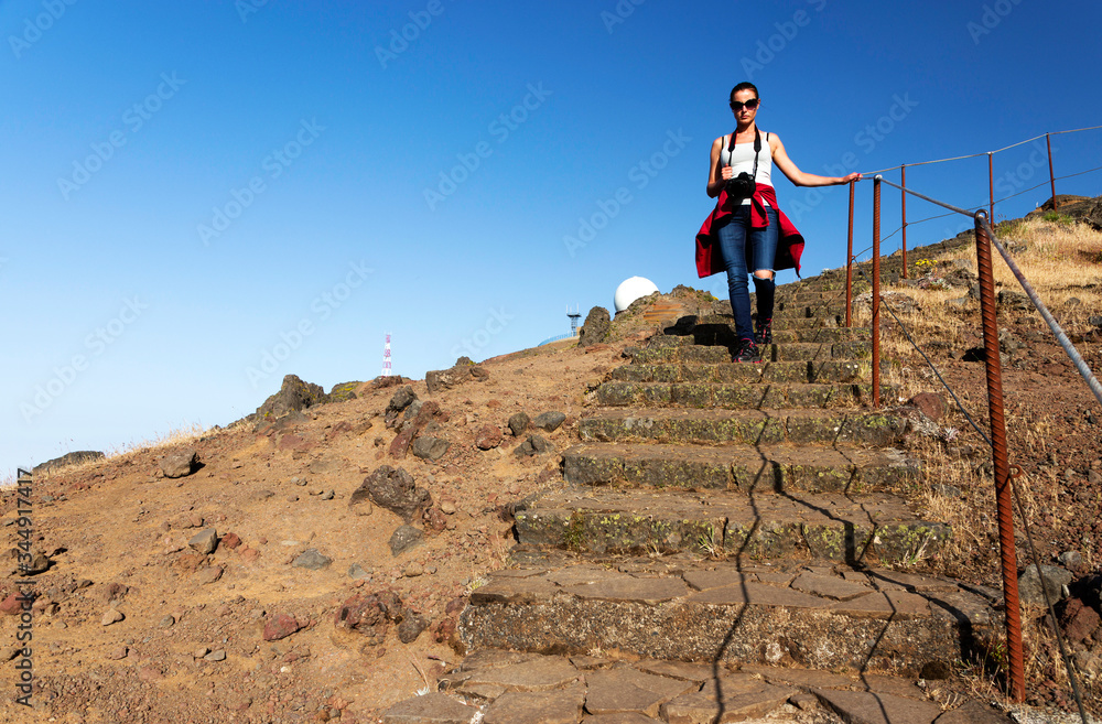 Young girl on the winding mountain trekking path at Pico do Areeiro, Madeira, Portugal