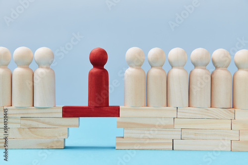 Not like everyone. Business risk. Leadership and superiority. People figures on bridge, one red person miniature on gap