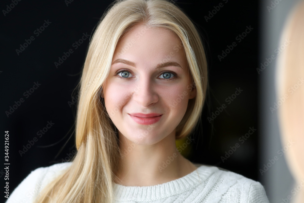 Smiling beautiful blonde woman looking in mirror Smiling beautiful blonde woman looking in mirror