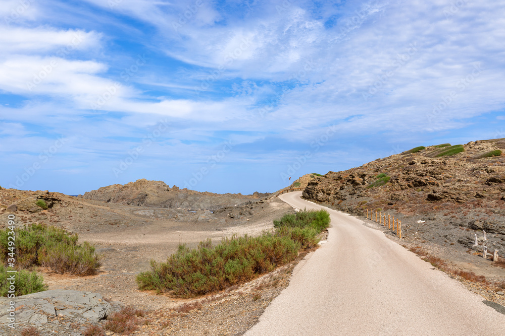 Scenic road on the island of Menorca with beautiful sky. Balearic islands, Spain Scenic road on the island of Menorca with beautiful sky. Balearic islands, Spain