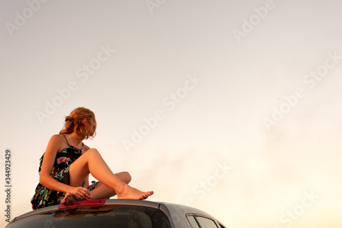 Young woman looking up at the sky. Girl looking towards the horizon. © SARA MAYA