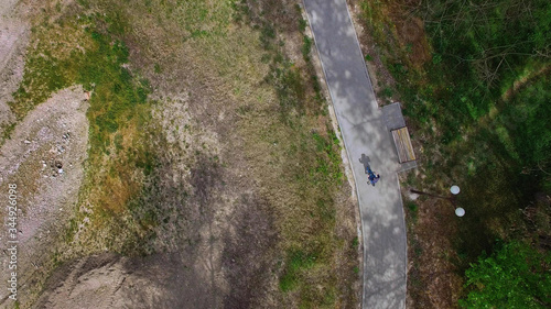 baby on bike rides along the path in the Park, the view from the drone