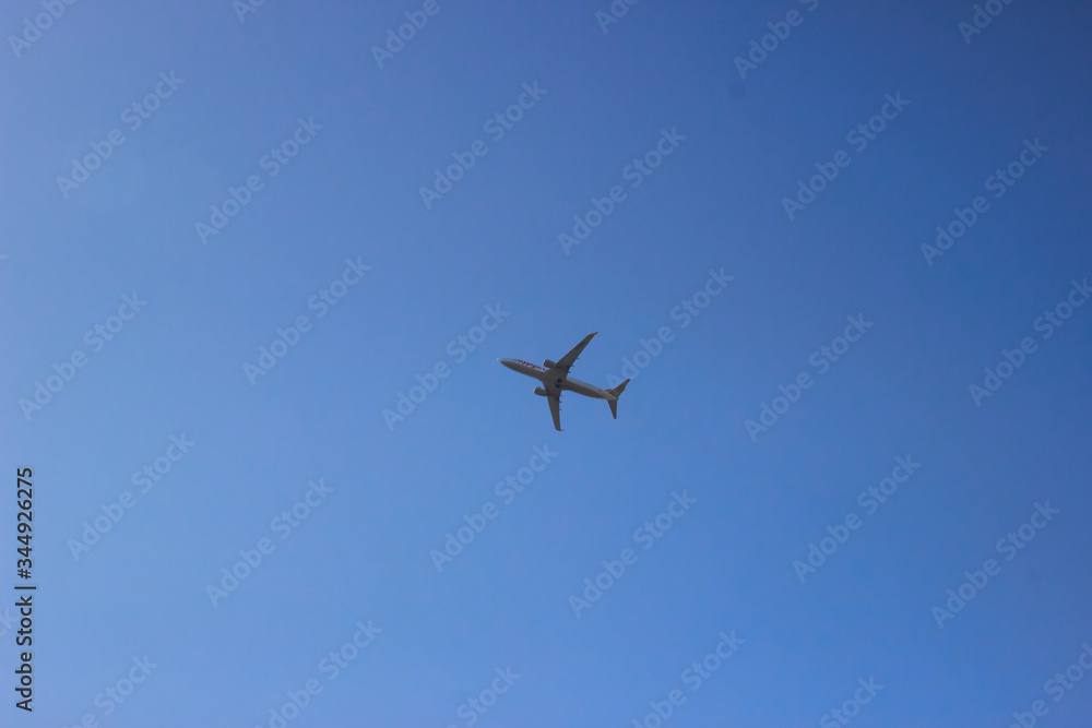 Passenger airplane in clean blue sky. Modern aircraft flying with tourists. Passenger airplane in clean blue sky. Modern aircraft flying with tourists.