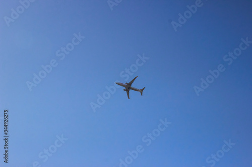 Passenger airplane in clean blue sky. Modern aircraft flying with tourists.