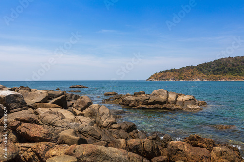 view from the rocky shore to the blue water on the island of Phuket Thailand © dadoodas