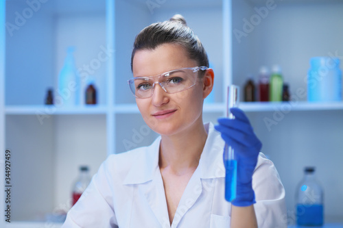 A female medical scientist works in a laboratory. Spcialist conducts experiments  develops auccin auctin from the virus. Coronavirus covid-19.