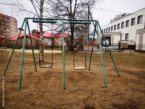 Abandoned playground with two old swings