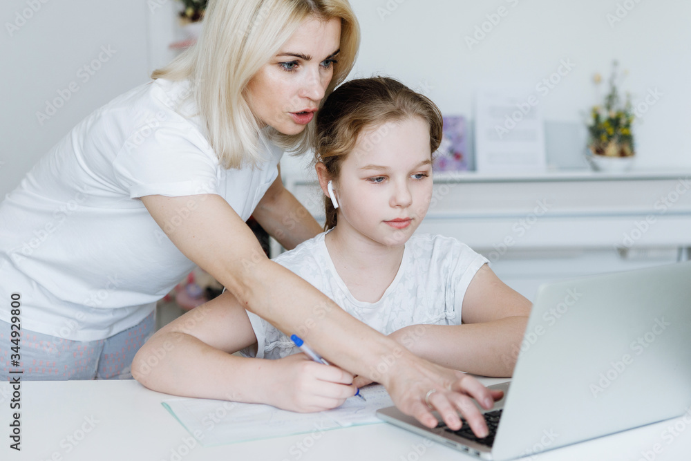 Girl with mom at the table with laptop. Girl with mom at the table with laptop.