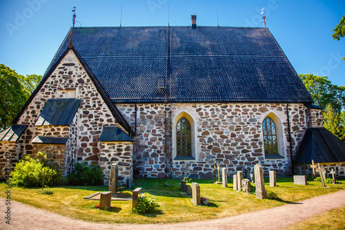 A medieval stone Nauvo Church (Nagu kyrka) from the middle of the 15th century stands in the middle of the village Kyrkbacken (Eng: Church hill). Storlandet Island, Turku Archipelago, Finland. photo